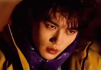 A Close Up Of A Person Wearing A Purple Jacket And A Yellow Jacket . GIF