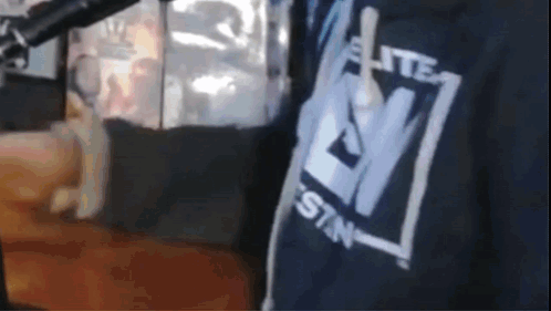 A Close Up Of A Person Wearing A Shirt That Says Elite Sin GIF