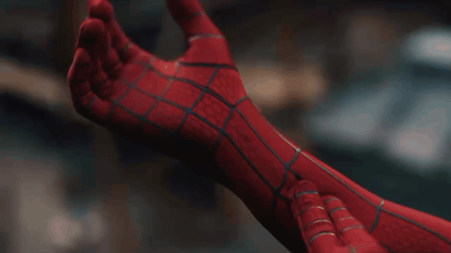 A Close Up Of A Person Wearing A Spiderman Suit GIF