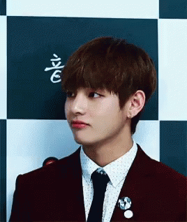 A Close Up Of A Person Wearing A Suit And Tie . GIF