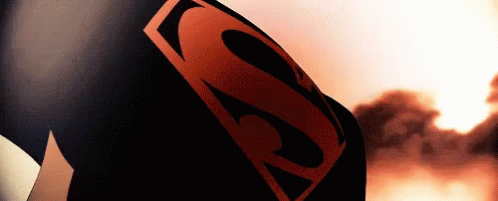 A Close Up Of A Person Wearing A Superman Costume With A Red S On It . GIF