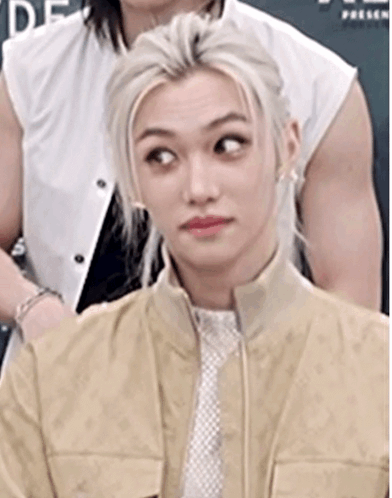 A Close Up Of A Person Wearing A Tan Jacket And Tie . GIF