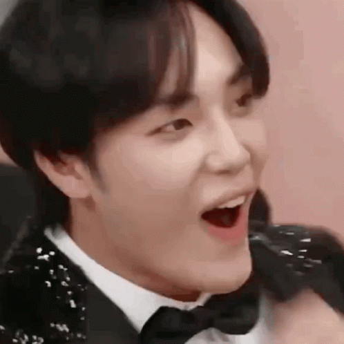 A Close Up Of A Person Wearing A Tuxedo And Bow Tie . GIF