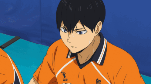 A Close Up Of A Person Wearing An Orange Shirt With Ics On It GIF