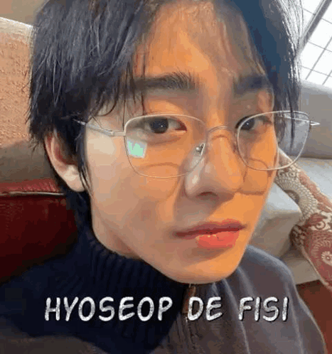 A Close Up Of A Person Wearing Glasses And A Black Sweater . GIF