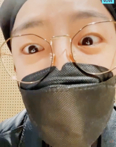 A Close Up Of A Person Wearing Glasses And A Mask That Says Vlive On The Bottom GIF
