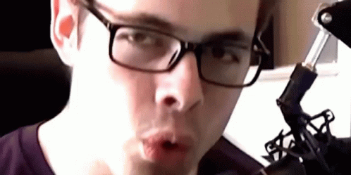 Close Up Of Person Wearing Glasses And Purple Shirt GIF