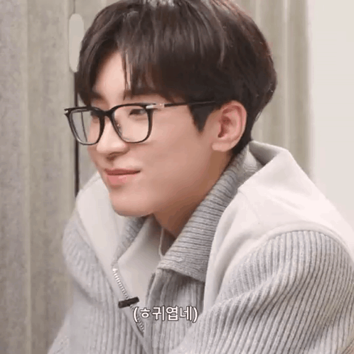 A Close Up Of A Person Wearing Glasses And A Sweater . GIF