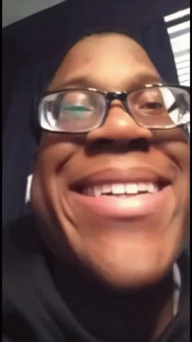 A Close Up Of A Person Wearing Glasses And Making A Funny Face GIF