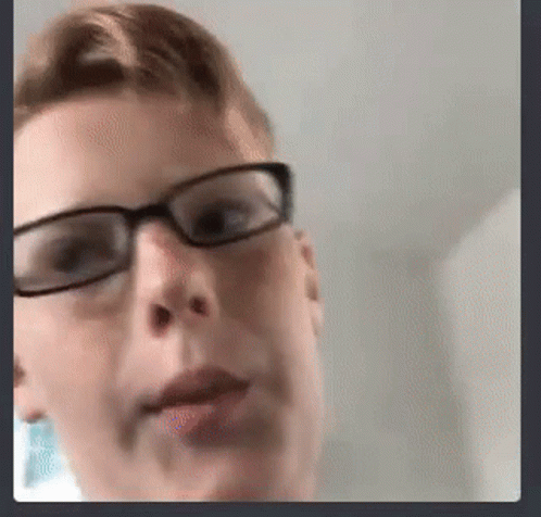 A Close Up Of A Person Wearing Glasses And Making A Funny Face . GIF