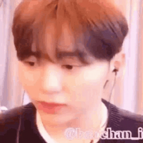 A Close Up Of A Person Wearing Headphones And A Black Sweater . GIF
