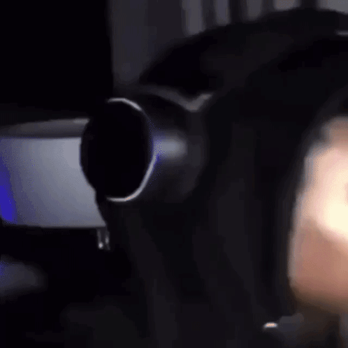 A Close Up Of A Person Wearing Headphones And A Mask . GIF