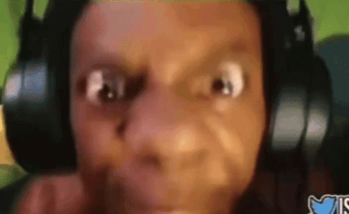 A Close Up Of A Person Wearing Headphones And Making A Face GIF
