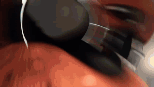A Close Up Of A Person Wearing Headphones On Their Neck . GIF