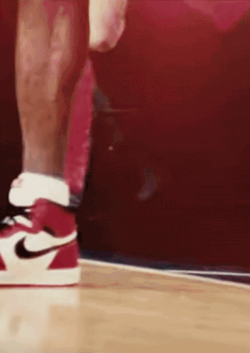 A Close Up Of A Person Wearing Red And White Nike Shoes GIF