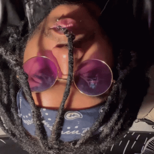 A Close Up Of A Person Wearing Sunglasses And A Bandana That Says ' Iin ' On It GIF
