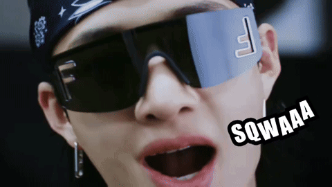 a close up of a person wearing sunglasses and a bandana that says sqwaaa on it