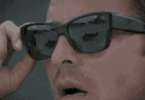 A Close Up Of A Person Wearing Sunglasses And A Pair Of Headphones . GIF