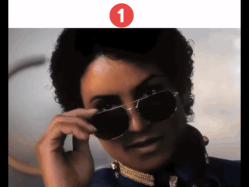 A Close Up Of A Person Wearing Sunglasses With The Number 1 On The Bottom GIF