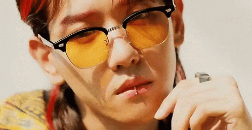 A Close Up Of A Person Wearing Yellow Sunglasses . GIF