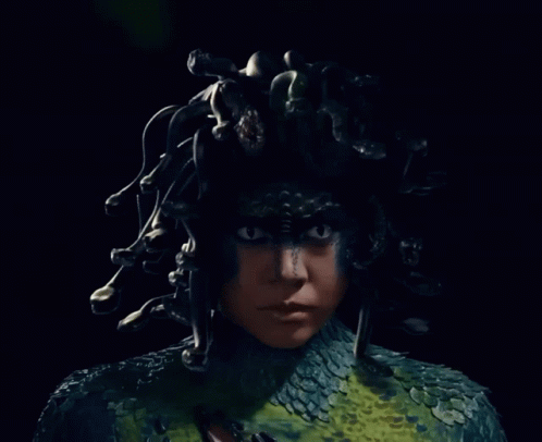 A Close Up Of A Person With A Snake Costume GIF