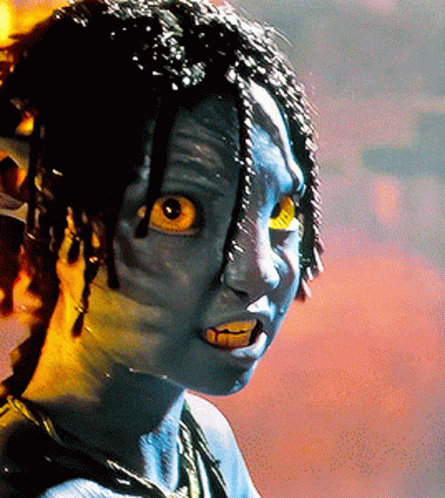 A Close Up Of A Person With Blue Paint On Their Face And Yellow Eyes GIF