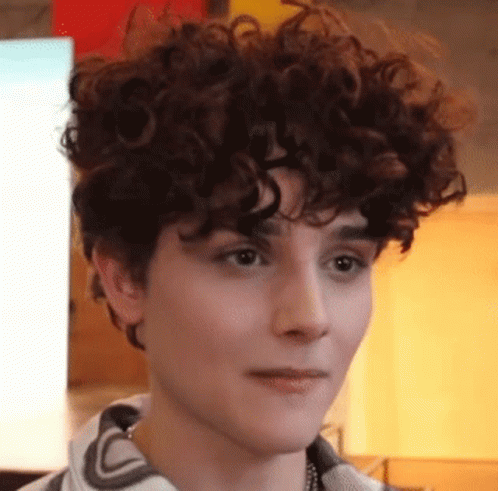 A Close Up Of A Person With Curly Hair Making A Face . GIF