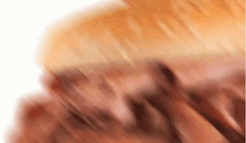 A Close Up Of A Piece Of Meat On A White Surface GIF