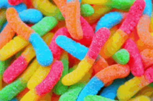 A Close Up Of A Pile Of Colorful Gummy Worms GIF