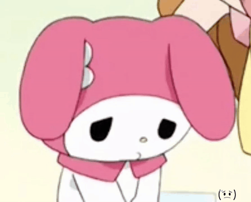 a close up of a pink bunny with a sad face on its face .