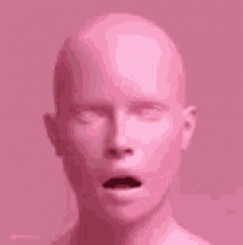 A Close Up Of A Pink Mannequin 'S Head With Its Mouth Open . GIF