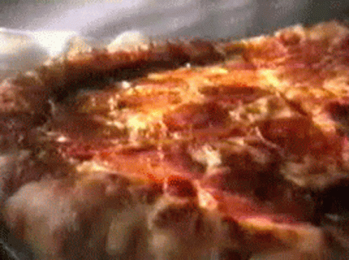 A Close Up Of A Pizza With A Lot Of Cheese GIF