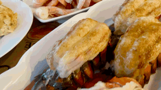 A Close Up Of A Plate Of Food On A Table With Shrimp . GIF