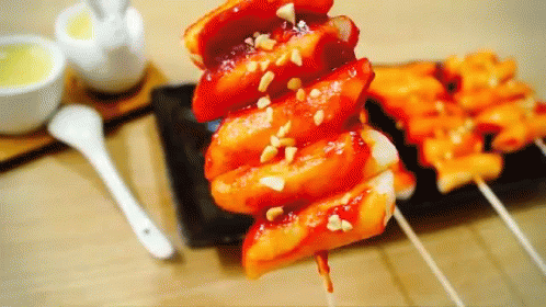 A Close Up Of A Plate Of Food With A Spoon On The Table GIF