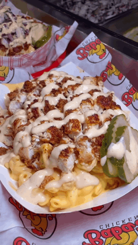 A Close Up Of A Plate Of Food With Chicken And Macaroni Cheese GIF