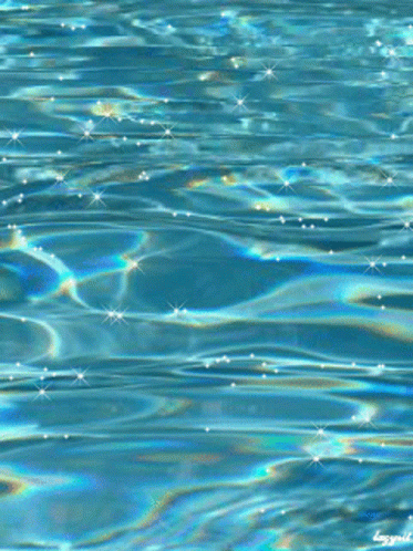 A Close Up Of A Pool Of Water With A Rainbow Colored Reflection GIF