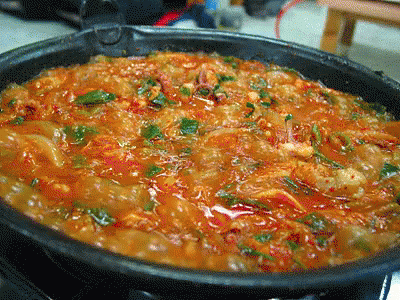 A Close Up Of A Pot Of Stew With Vegetables GIF