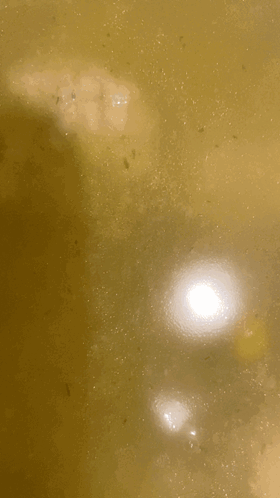 A Close Up Of A Pot Of Water With A Few Bubbles In It GIF
