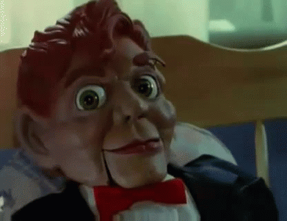 A Close Up Of A Puppet Wearing A Tuxedo And Bow Tie . GIF
