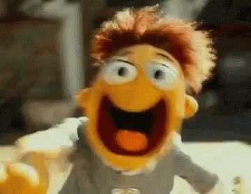 A Close Up Of A Puppet With Its Mouth Open And A Tongue Sticking Out . GIF