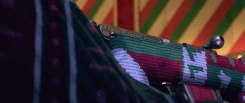 A Close Up Of A Purse With A Red Green And White Pattern On It GIF