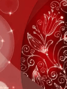 A Close Up Of A Red Background With Flowers And Swirls On It GIF