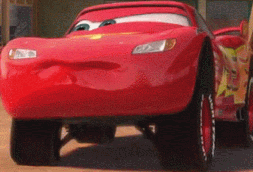 A Close Up Of A Red Car With A Face On It GIF