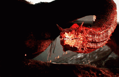 A Close Up Of A Red Dragon With Sharp Teeth Looking At The Camera GIF