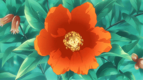 a close up of a red flower with green leaves in the background