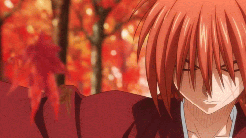 A Close Up Of A Red Haired Anime Character With A Blurred Background GIF