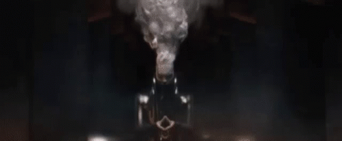 A Close Up Of A Robot 'S Face In A Dark Room Looking At The Camera . GIF
