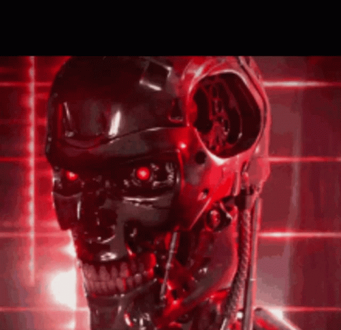 A Close Up Of A Robot 'S Head With Red Lights Behind It GIF