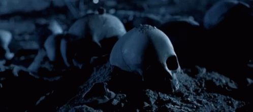 A Close Up Of A Robot With A Gun And A Flame In The Background GIF