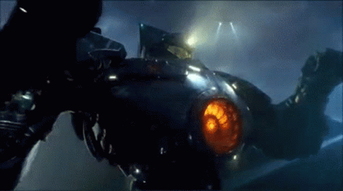 A Close Up Of A Robot With A Red Light Coming Out Of It 'S Mouth . GIF